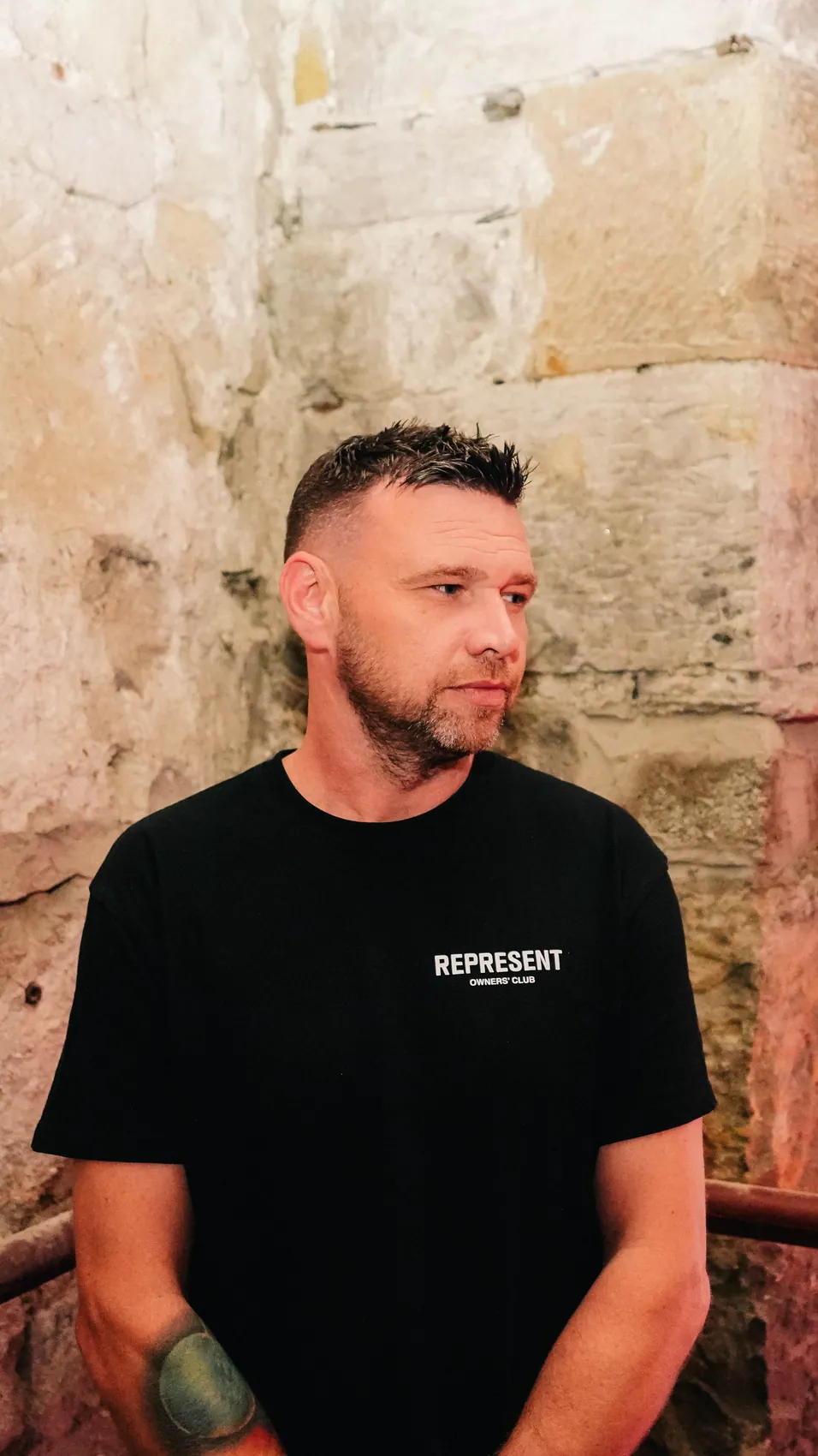 David Nimmo standing against a stone wall